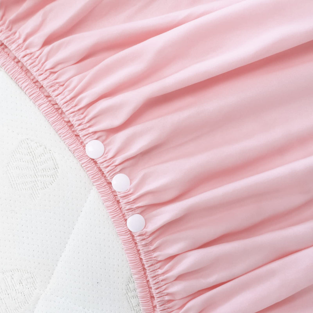 Biloban crib skirt pink pleated side view demonstrates easy attachment and secure fit