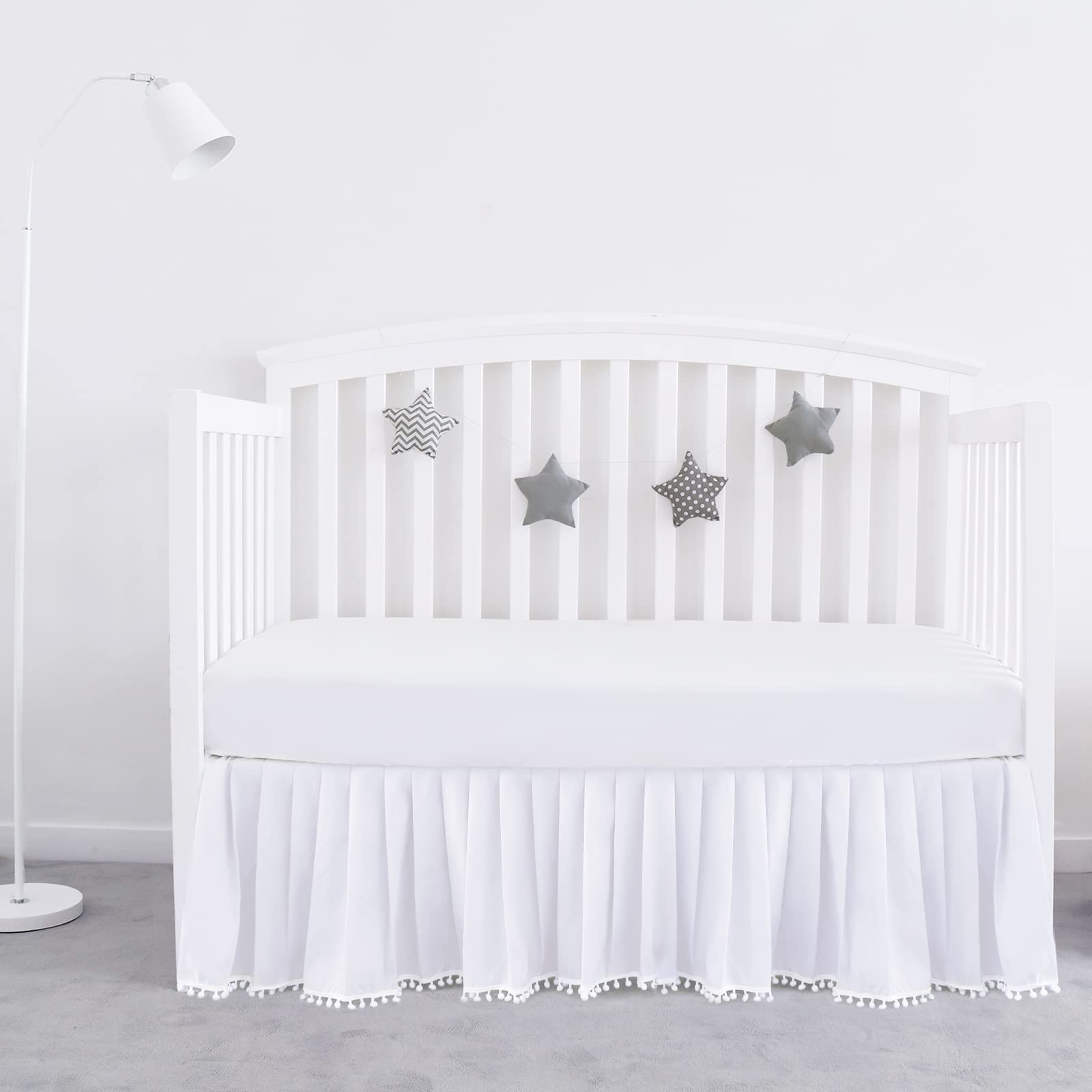 Biloban crib skirt white pleated pompoms adds stylish dimension to nursery.