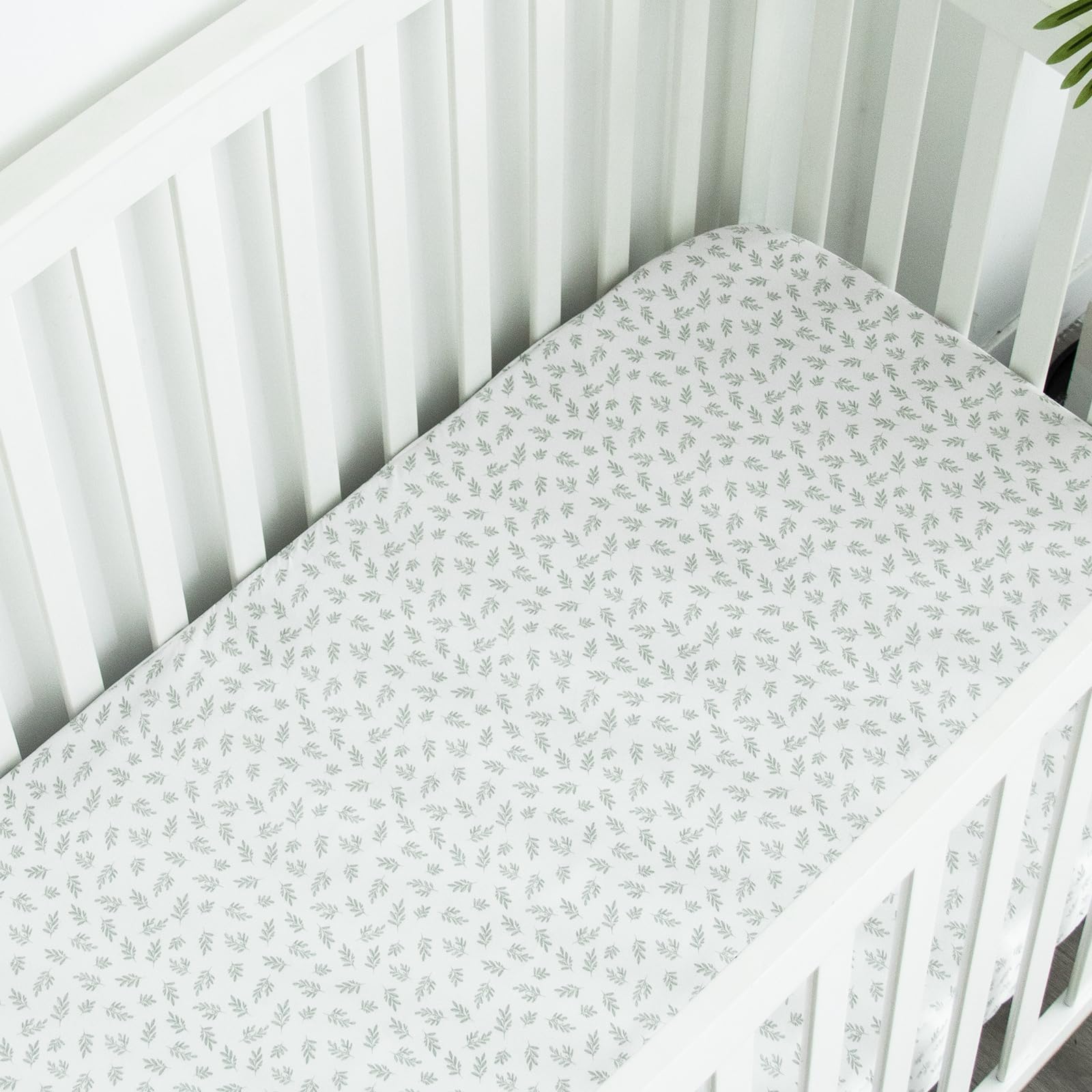 Biloban mini crib sheet nursery decor color options in Aqua Leaf and neutrals.