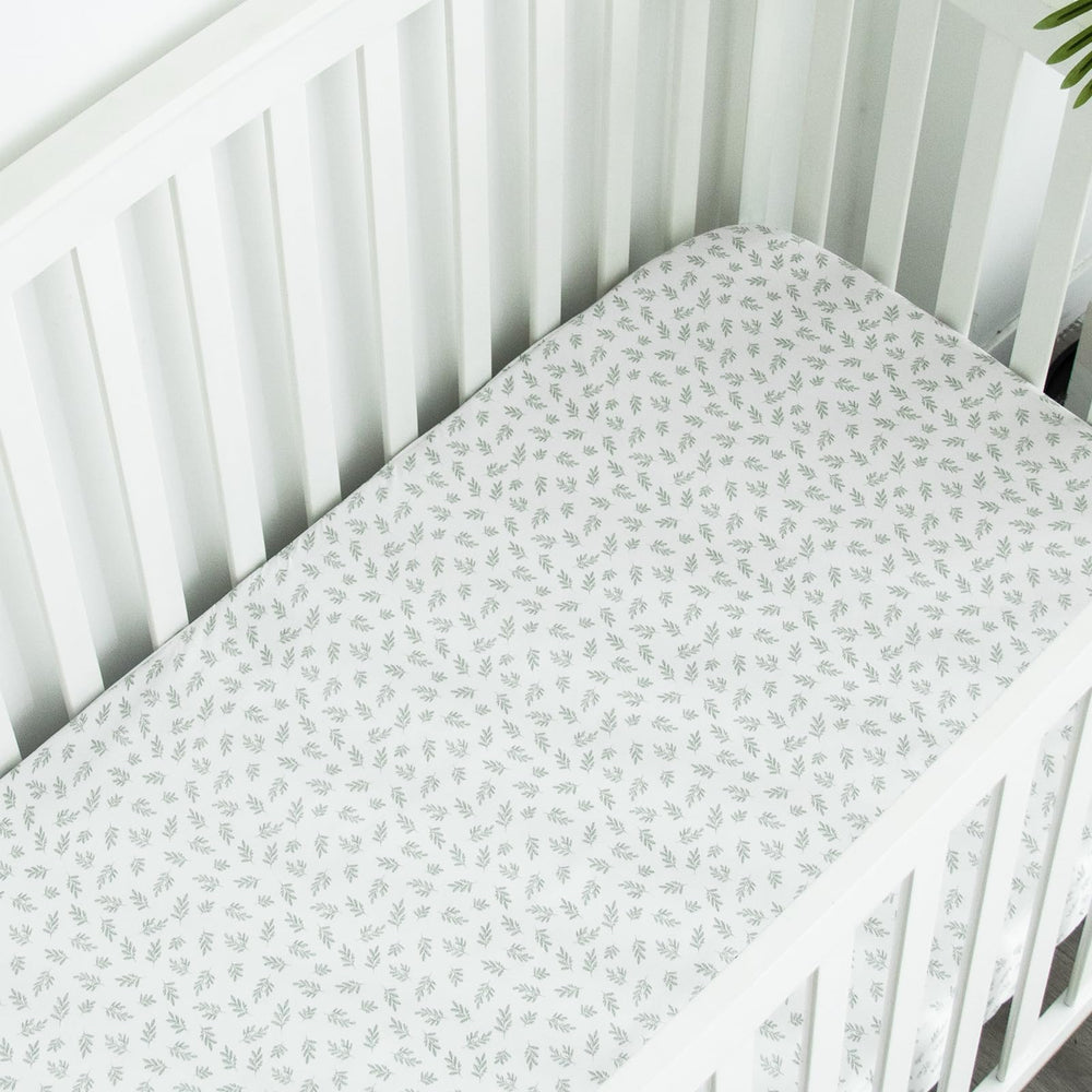Biloban mini crib sheet nursery decor color options in Aqua Leaf and neutrals.