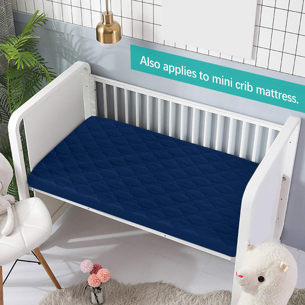 Biloban pack-and-play mattress pad gray-navy folded demonstrates easy tuck-in fit for quick setup.