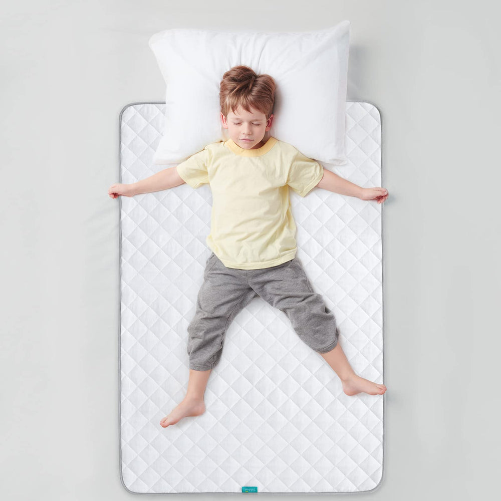 Biloban bed pad used in a home setting for pets or kids