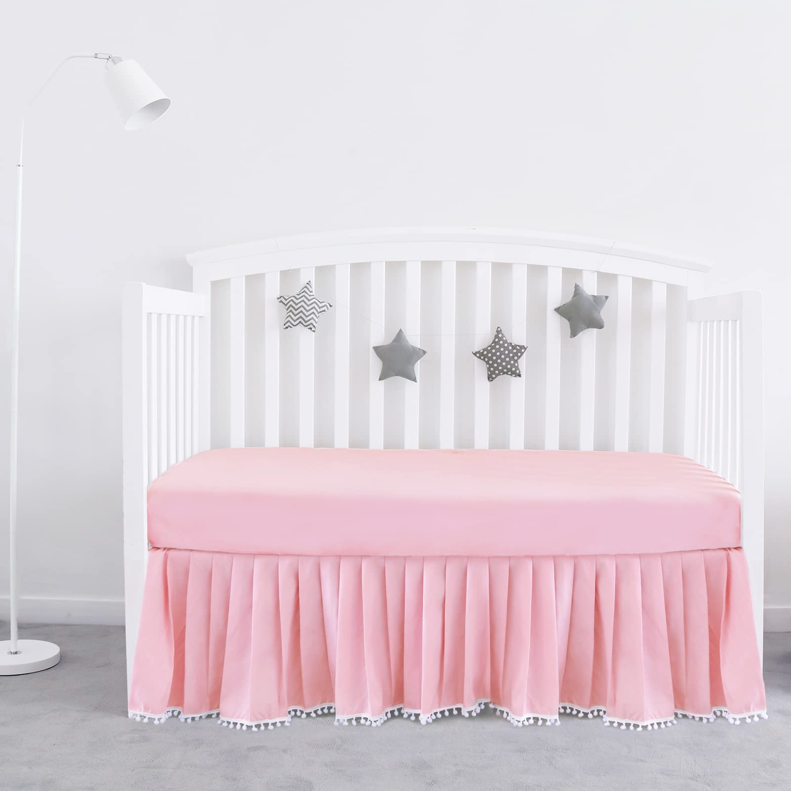 Biloban pink crib skirt with pleats and pompoms adds a polished look to standard crib