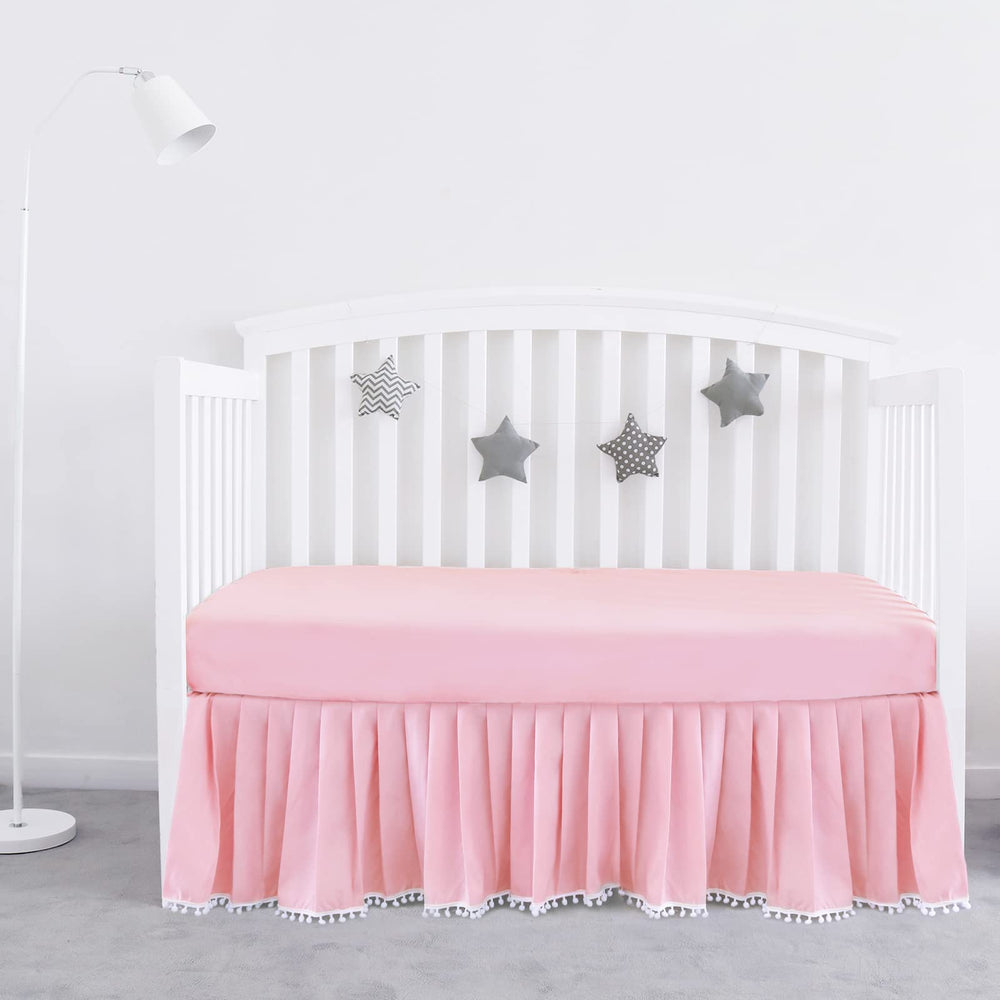 Biloban pink crib skirt with pleats and pompoms adds a polished look to standard crib