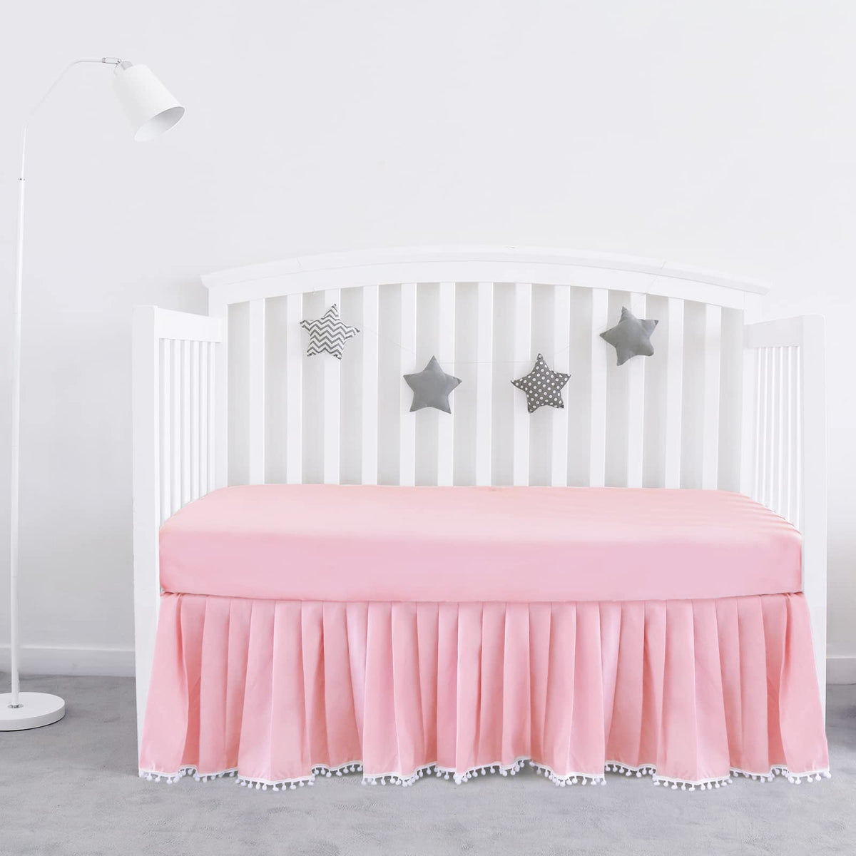 Biloban pink crib skirt with pleats and pompoms adds a polished look to standard crib