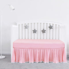 Biloban pink crib skirt with pleats and pompoms adds a polished look to standard crib