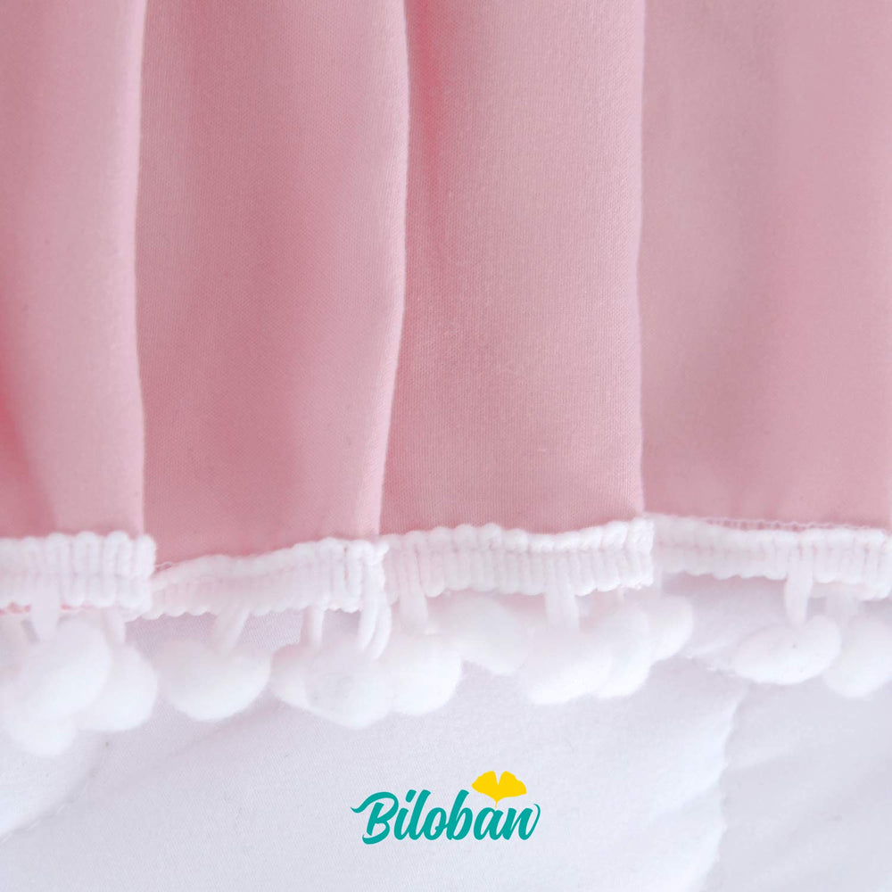Biloban pink crib skirt side view shows soft fabric and neat drop