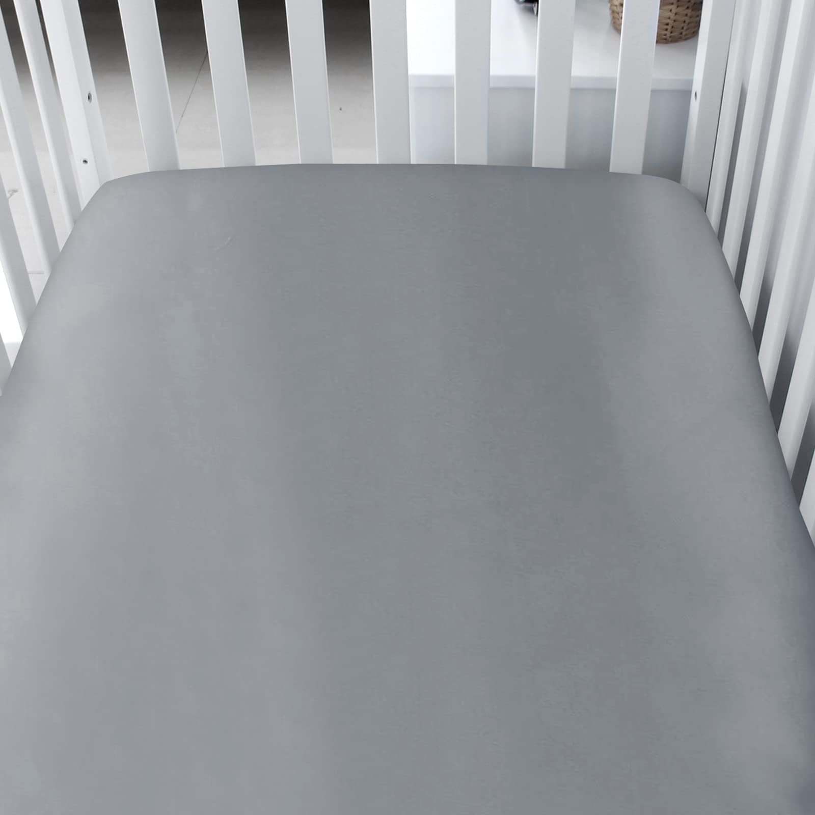 Biloban satin crib sheets with elastic-band fit demonstrate snug, secure corners for a flat, cozy mattress.