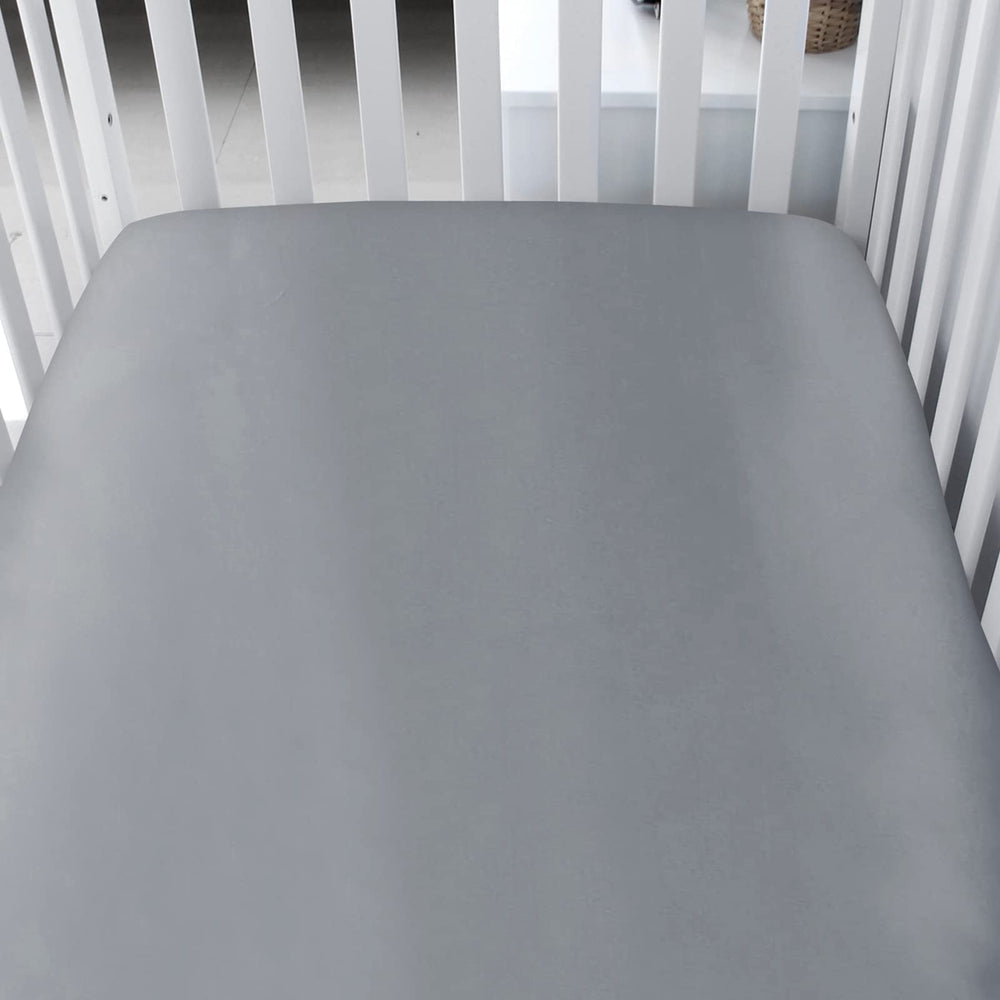Biloban satin crib sheets with elastic-band fit demonstrate snug, secure corners for a flat, cozy mattress.