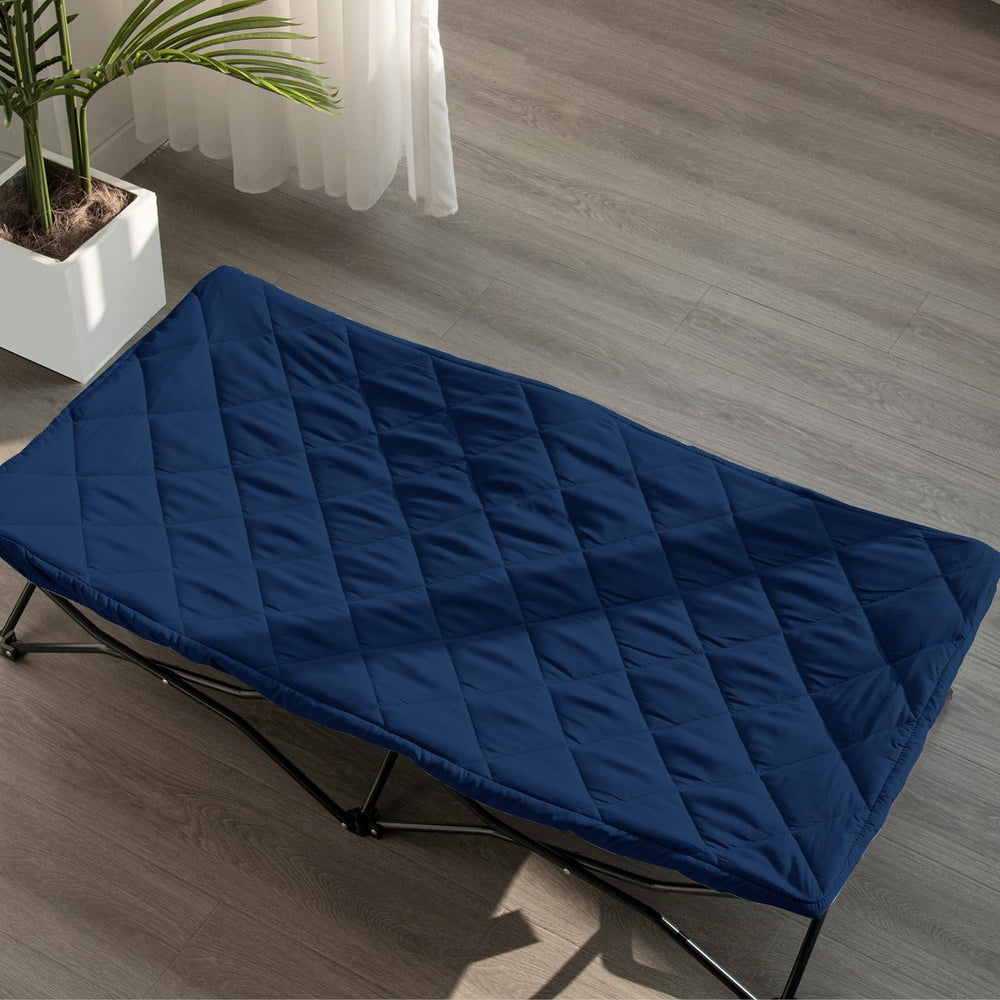 Biloban Joovy Travel Cot navy sheet highlighting breathable quilted comfort.