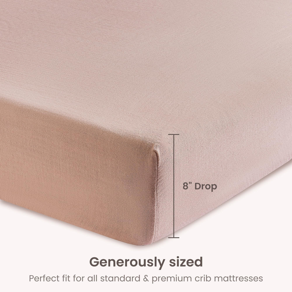 BIOWEAVES dusty pink bassinet sheet on mattress highlighting color and fit