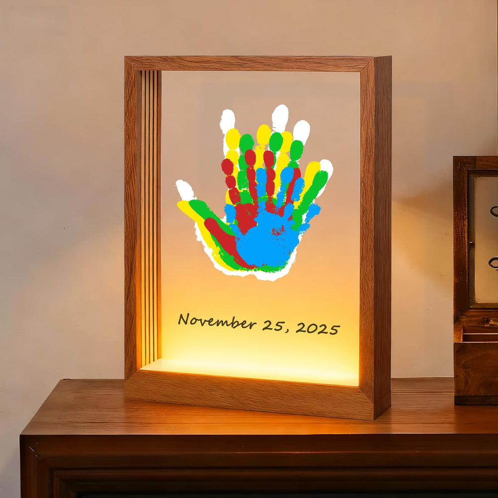 Bixinyo family handprint kit with light frame close-up highlighting a warm keepsake moment