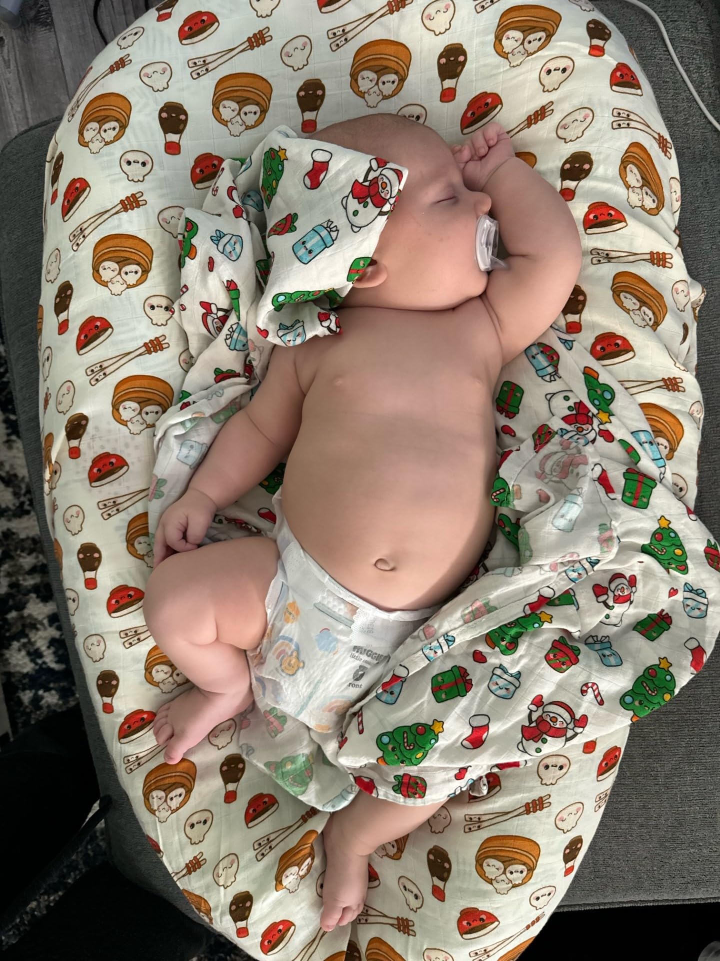 BlessEver muslin swaddle emoji-print design adds playful visuals during cuddles.