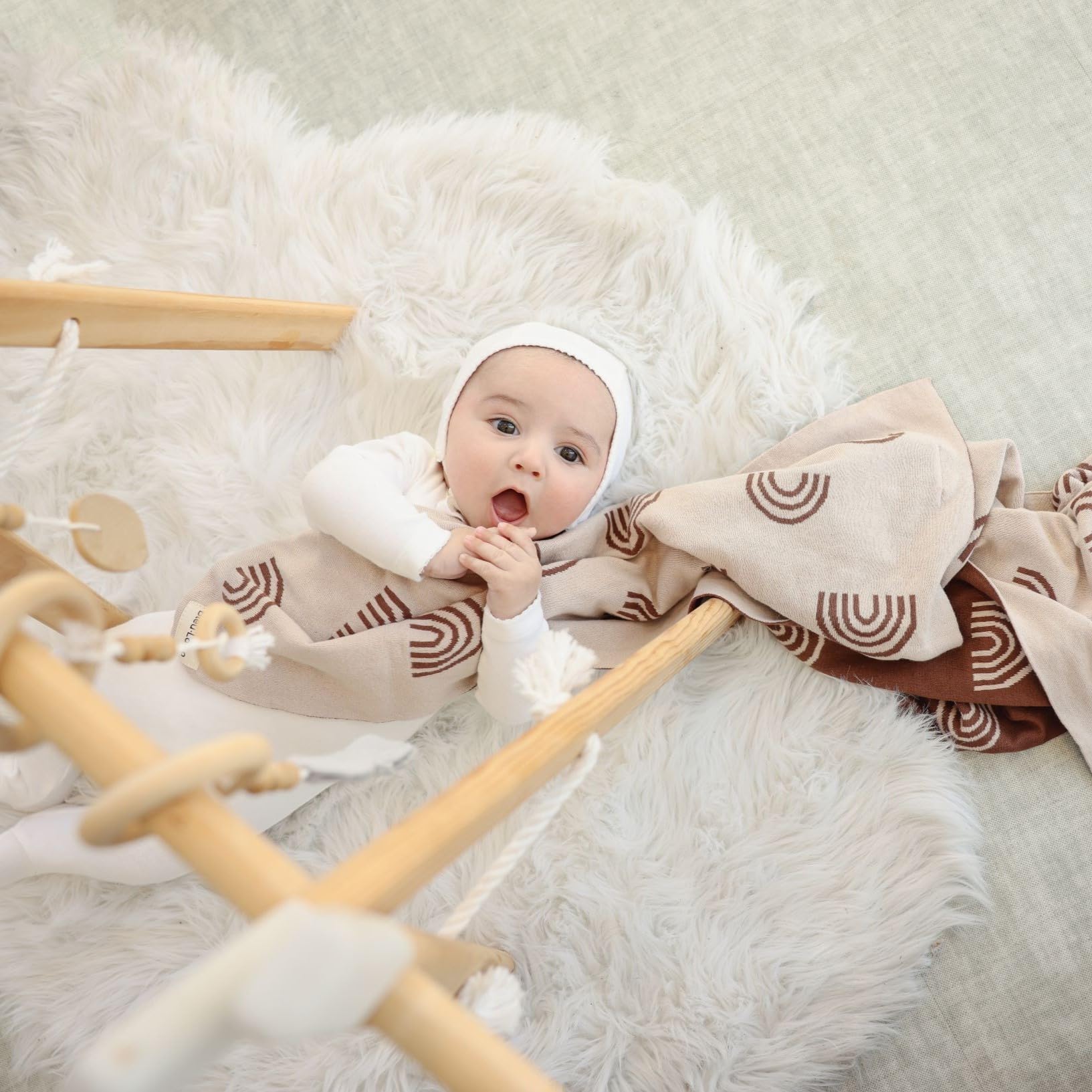 Bleu La La baby blanket rainbow-taupe draped in stroller for all-season comfort.