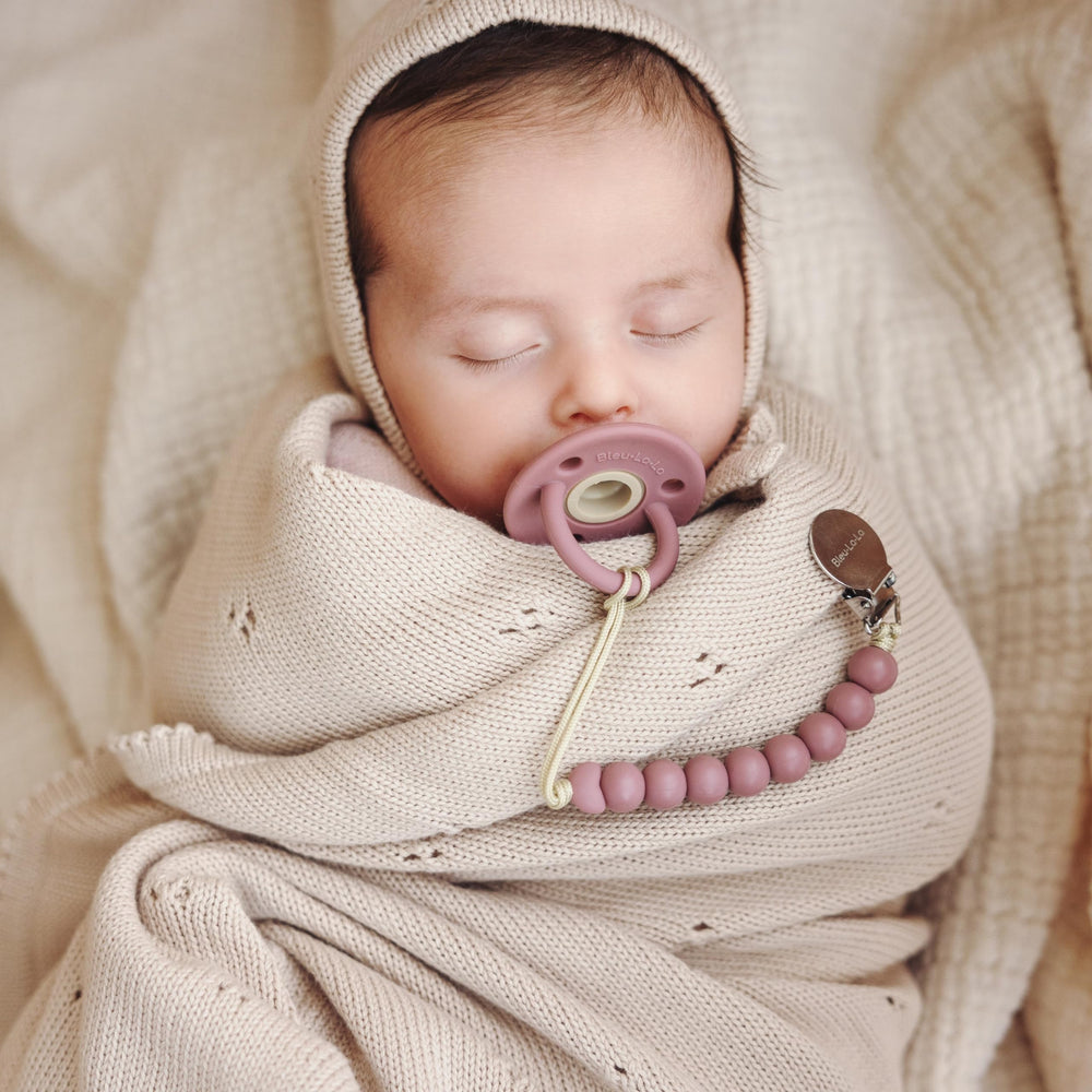 Bleu La La blanket laid on a nursery crib complements modern decor