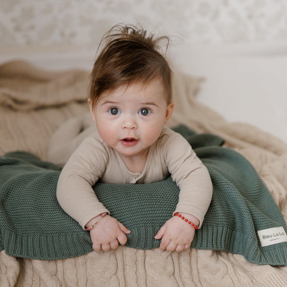 Bleu La La heritage-knit blanket in stroller scene shows easy travel-compatibility.