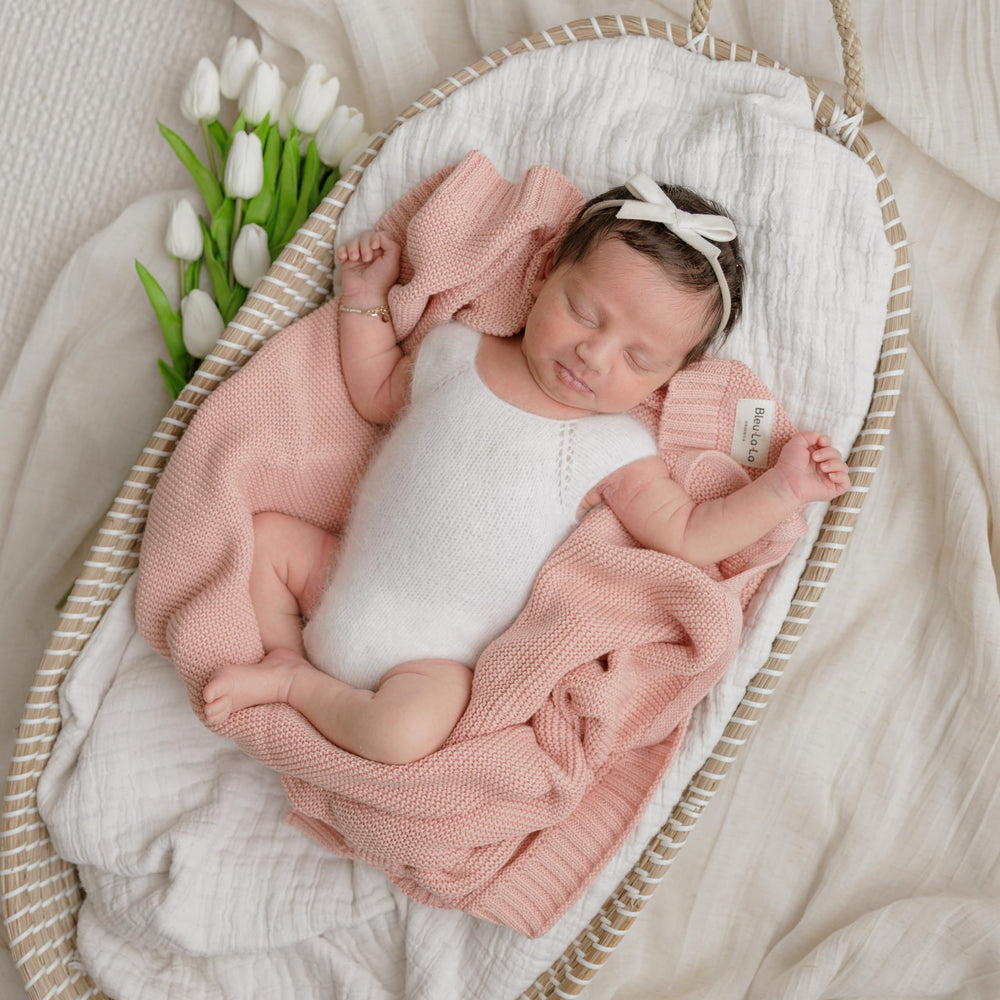 Bleu La La heritage knit blanket in car seat demonstrates versatile wrap options.