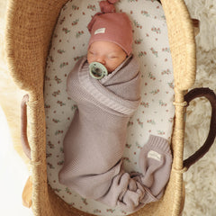 Bleu La La blanket with baby wrapped in swaddle demonstrates cozy, secure warmth for newborns.