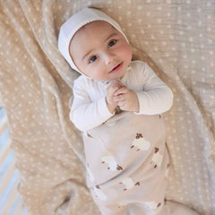 Bleu La La knit baby swaddle in stroller illustrates secure snug wrap on the go