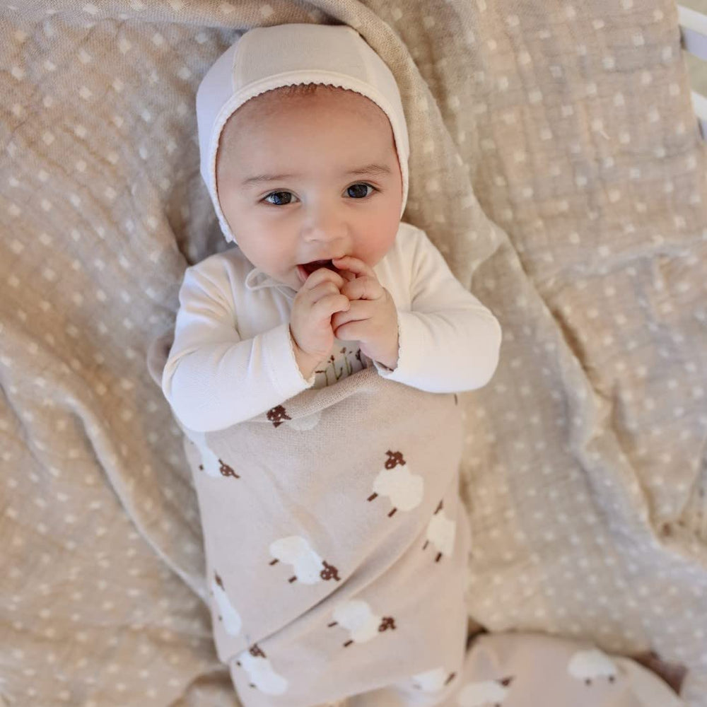 Bleu La La knit baby swaddle in travel setting demonstrates portable comfort