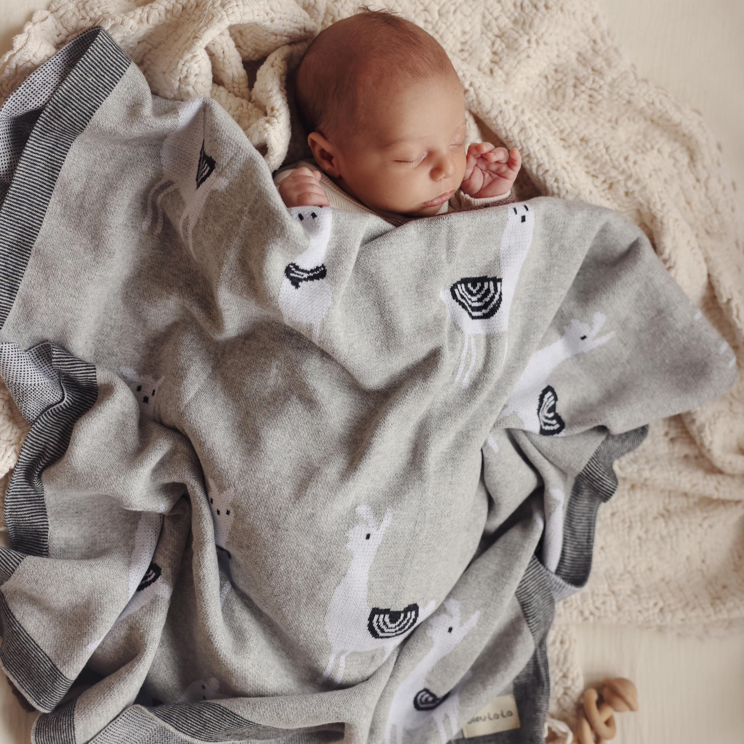 Bleu La La llama pink crib blanket adds cozy touch to the nursery decor