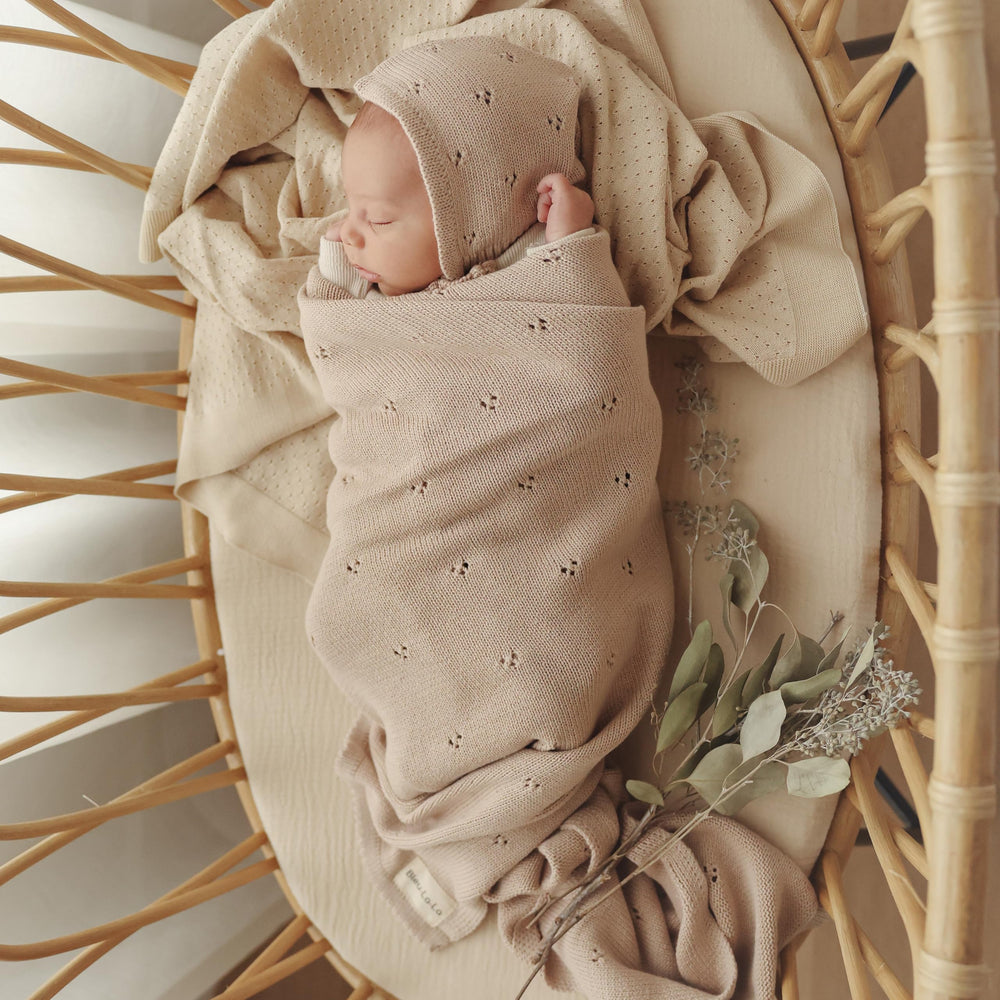 Bleu La La pointelle blanket on baby lap demonstrates gentle weight and wrap-friendly snugness