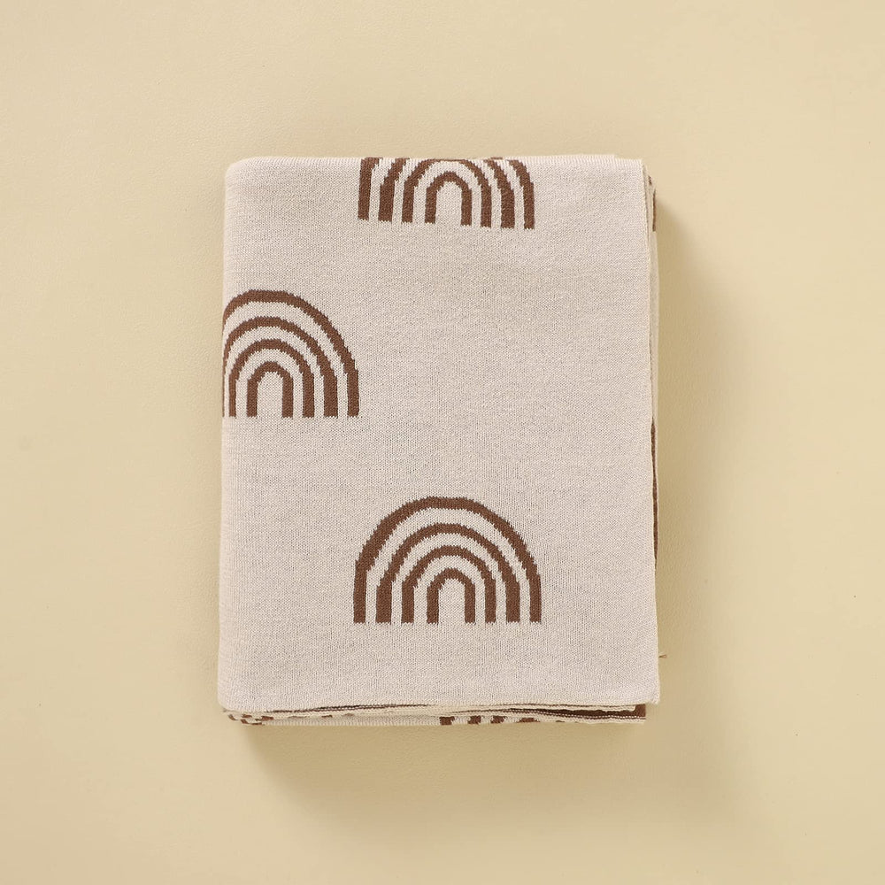 Bleu La La rainbow-taupe blanket highlights charity initiative supporting fertility causes.