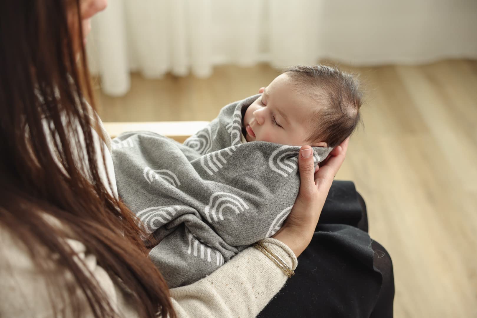 Bleu La La swaddle-ready rainbow-taupe blanket in nursery setting.