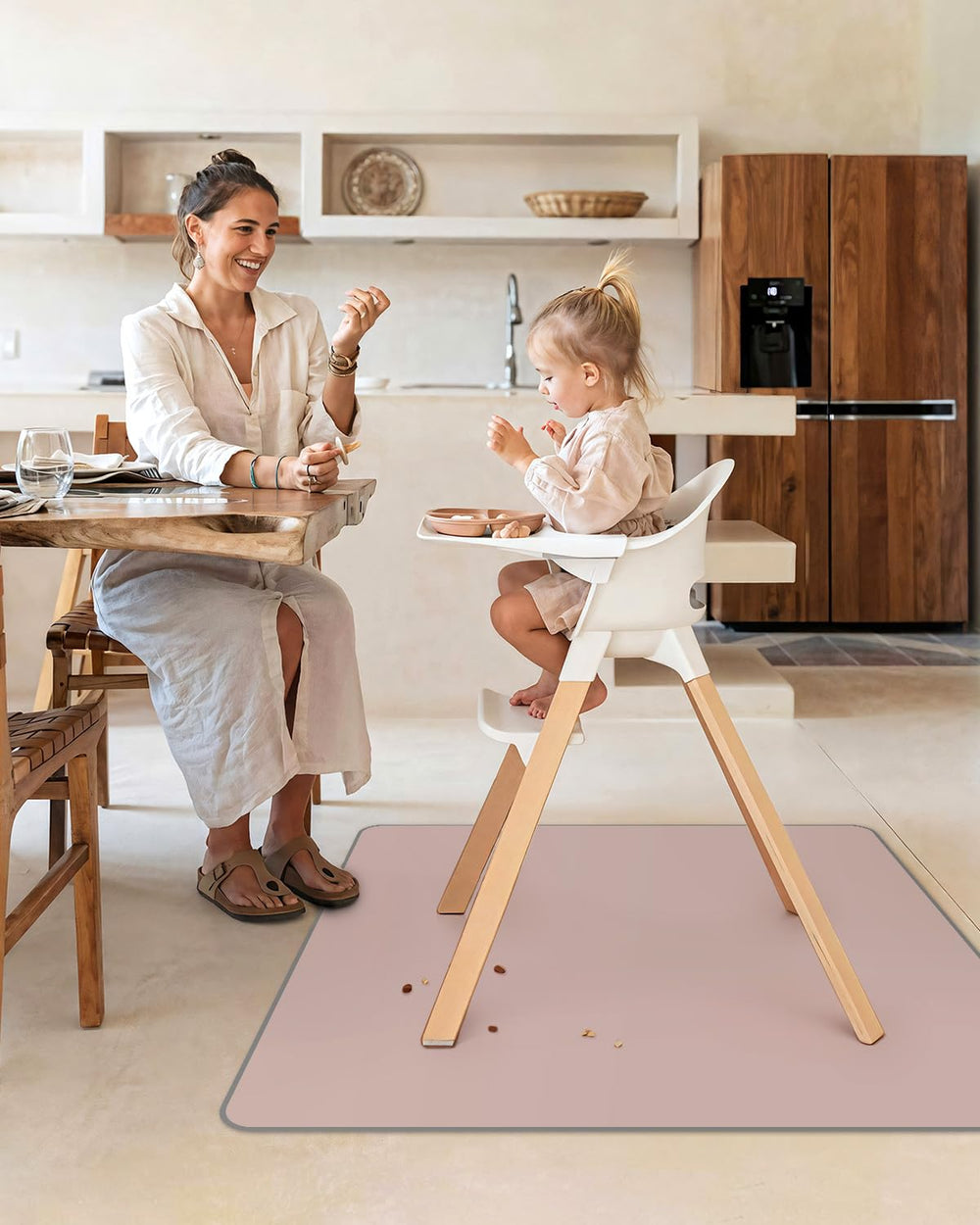 Blissful Diary 50.4 inch blush pink splat mat provides ample coverage under high chairs.