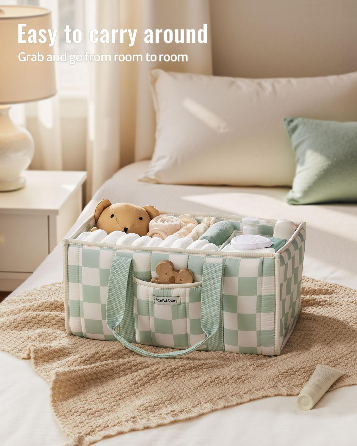 Blissful Diary checkered diaper caddy outer pocket holds pacifiers and small essentials for quick access.