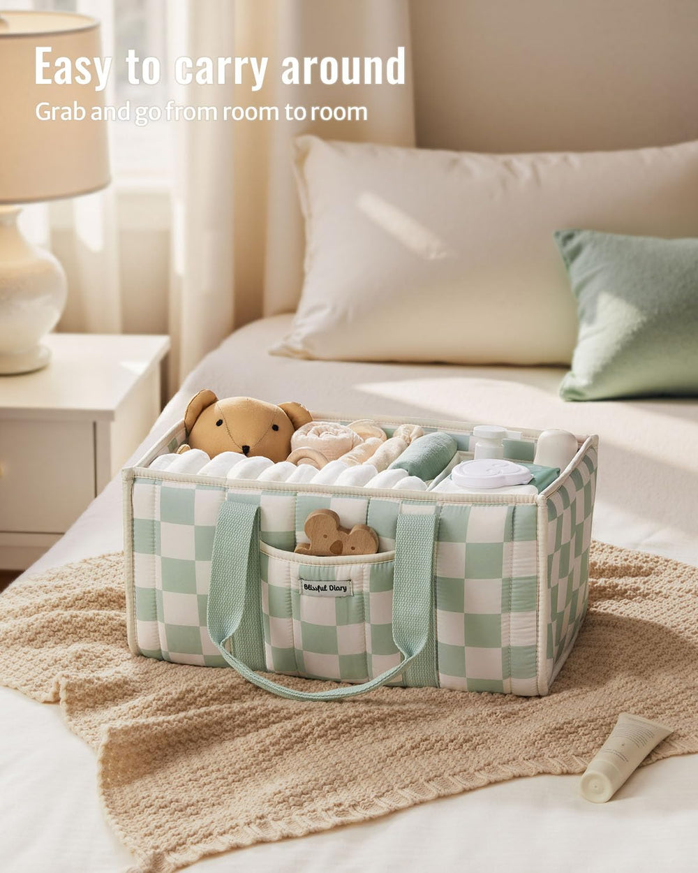 Blissful Diary checkered diaper caddy outer pocket holds pacifiers and small essentials for quick access.