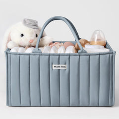 Blissful Diary diaper caddy in dusty blue on a changing table for easy access to newborn essentials.