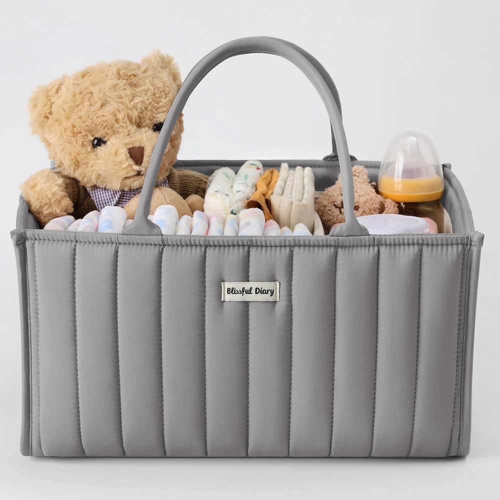 Blissful Diary diaper caddy organizer on changing table with nappies and wipes within easy reach.