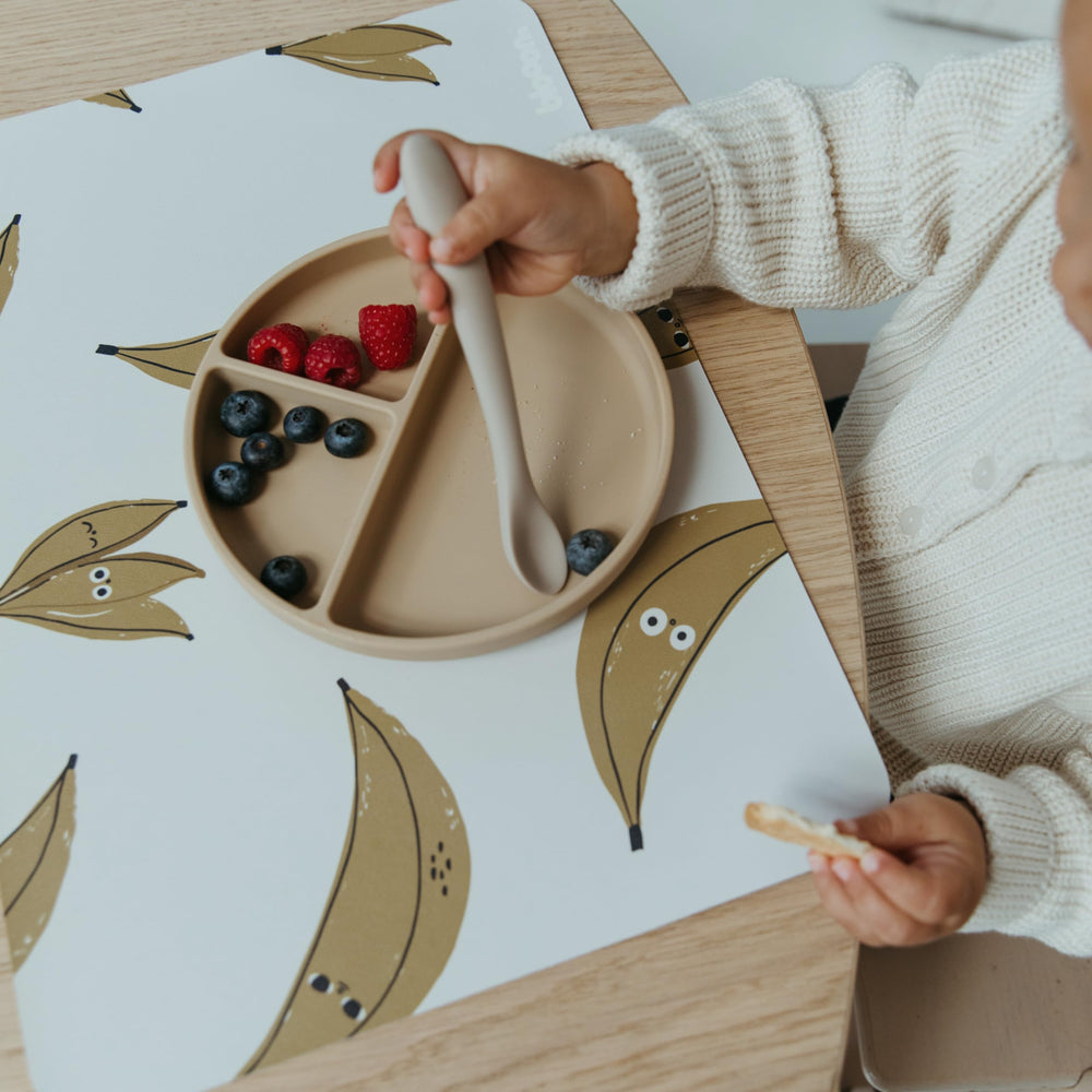 Blooom Banana placemat with wipeable surface simplifies cleanup after meals and snacks.
