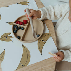 Blooom Banana placemat with wipeable surface simplifies cleanup after meals and snacks.