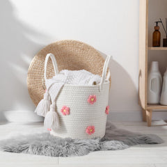 Blushtier round rope storage basket shown in a living room setting.