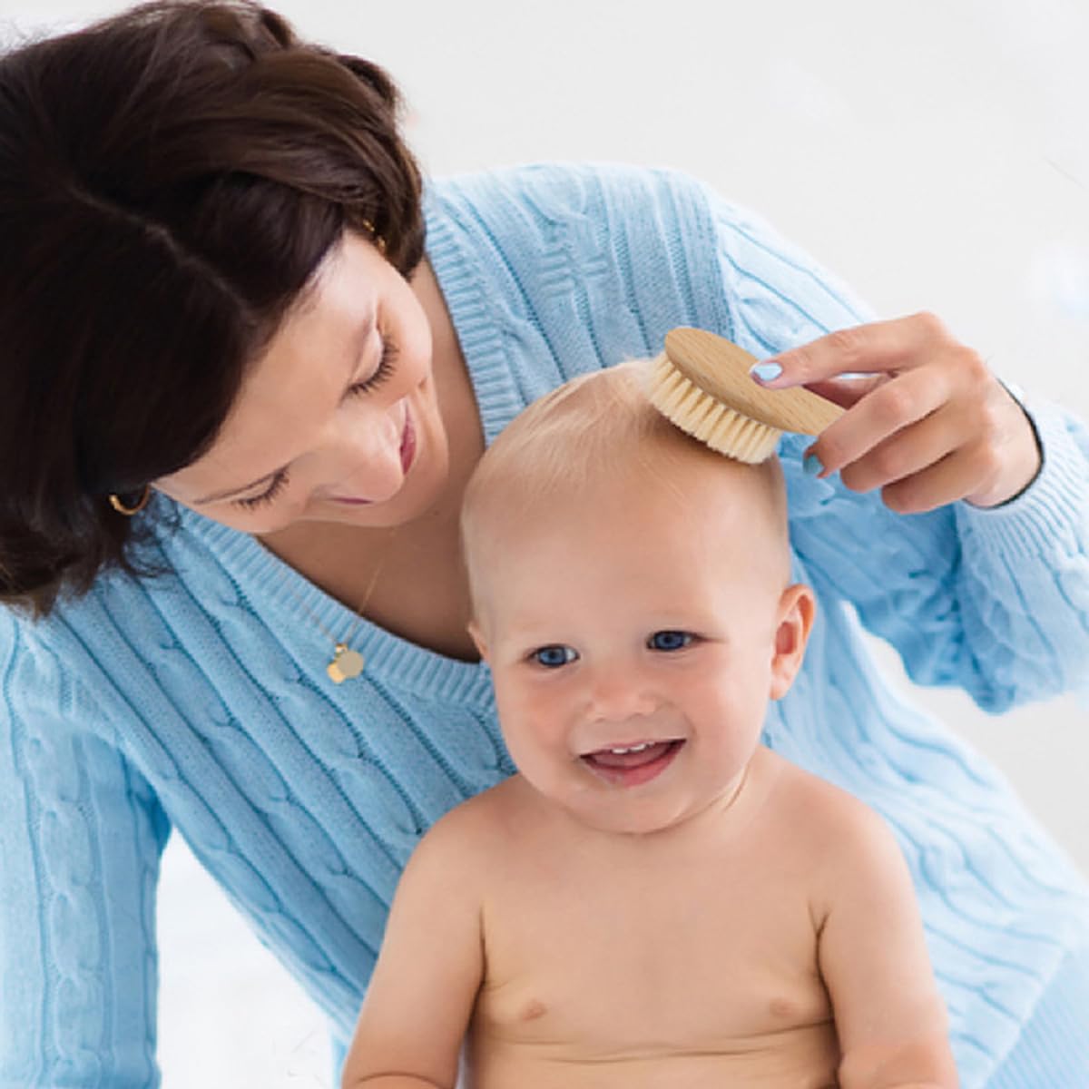 BoAn baby skin safe brush in use during gentle bath and brushing.