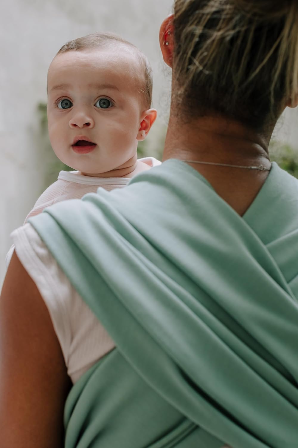 Boba wrap cradling newborn in snug embrace.