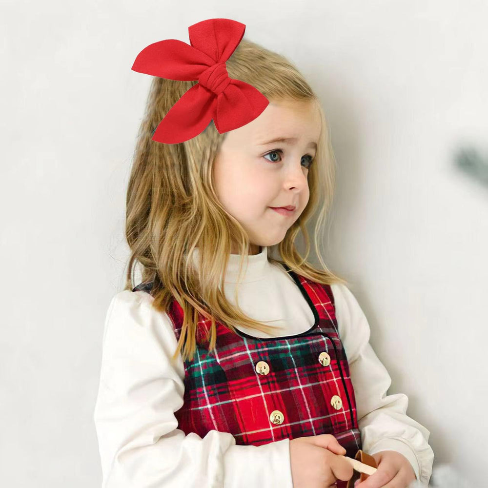 BOENBE LOVED yellow bow on a girl with a stylish outfit.