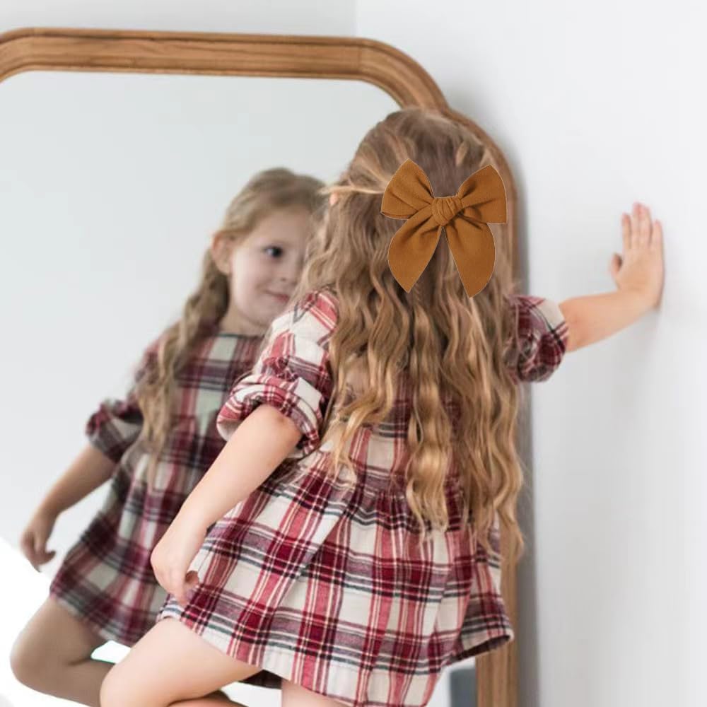 BOENBE LOVED yellow bow worn by a toddler for a cute everyday look.