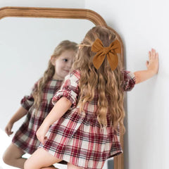 BOENBE LOVED yellow bow worn by a toddler for a cute everyday look.