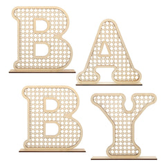 Boho rattan baby letters on table centerpiece for charming nursery decor.