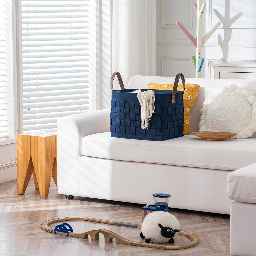 boldmonkey blankets basket navy on floor protecting surfaces while organizing items.