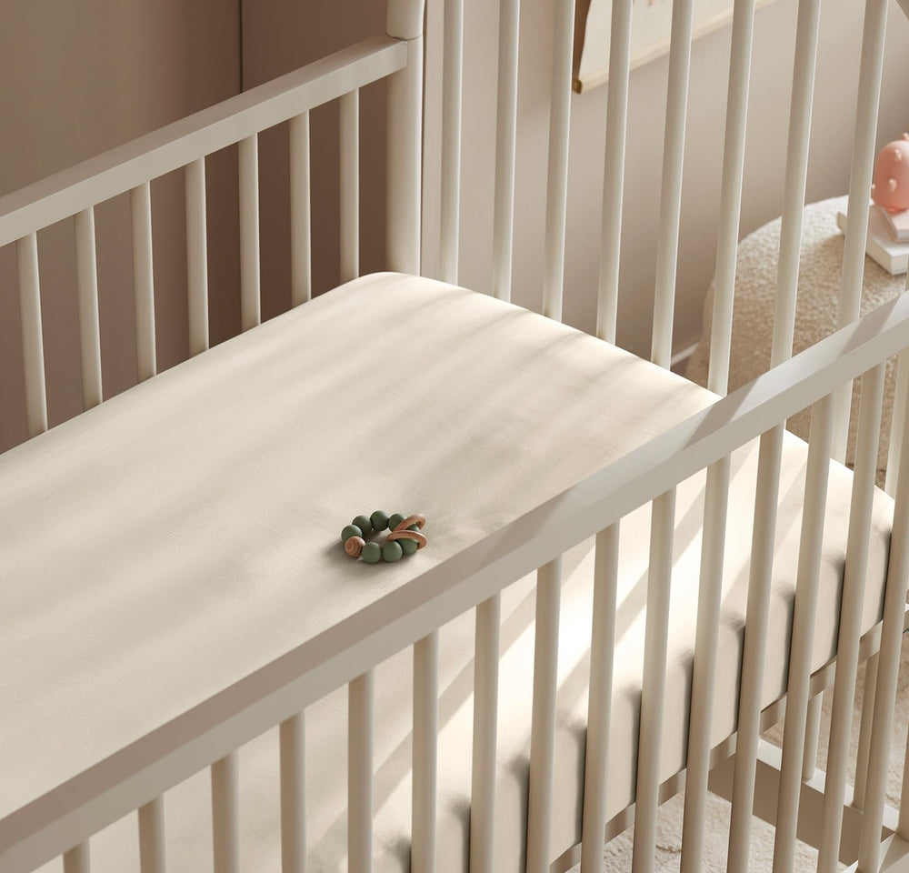 Boll & Branch Signature crib sheet fits standard crib mattress with secure setup.
