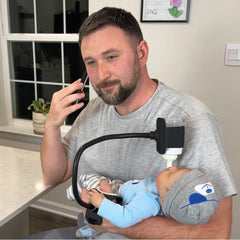 BottlesBuddy bottle holder with wrist-strap secures bottle for hands-free feeding.