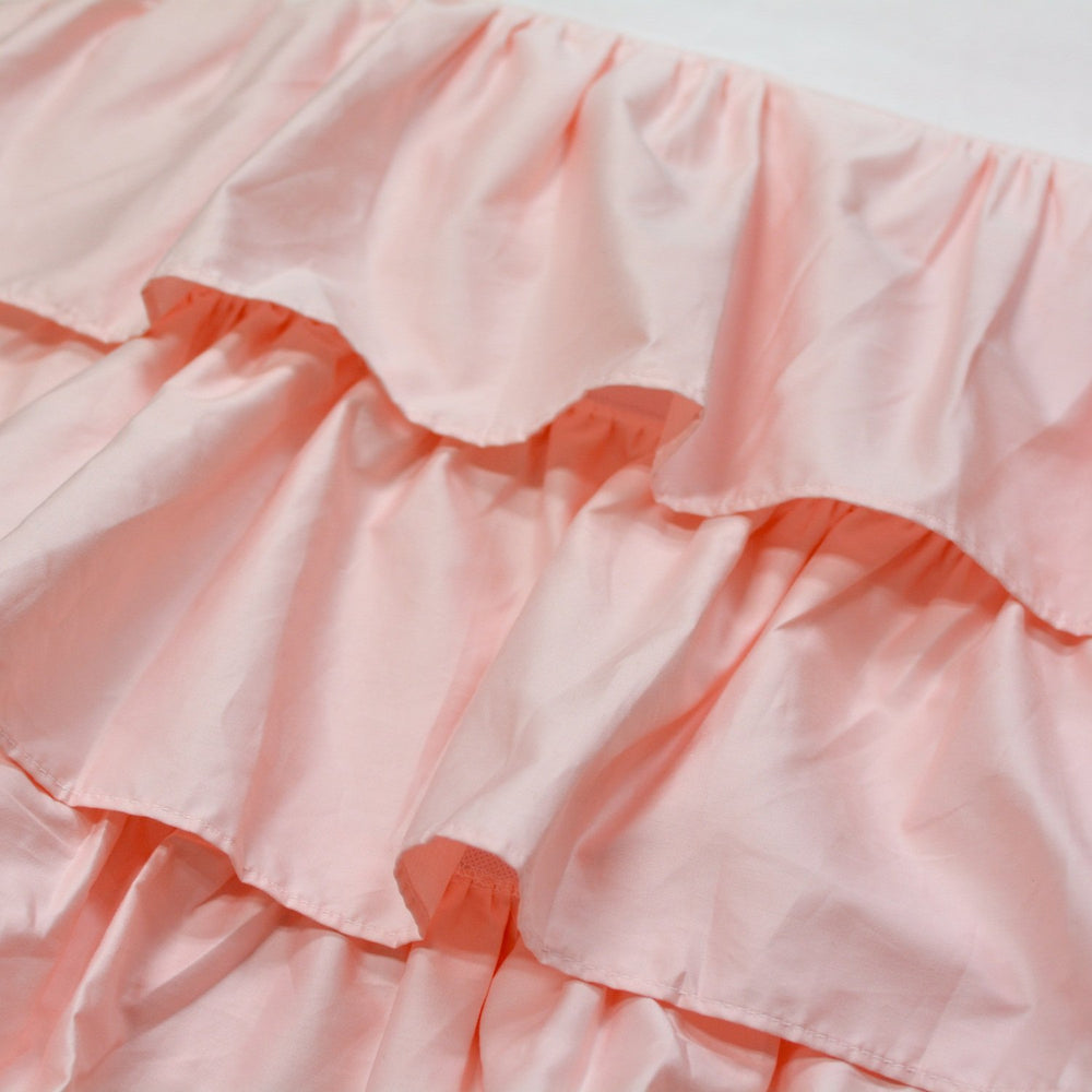 Brandream four-sided triple-layer crib skirt closeup highlighting secure fit around posts and easy placement