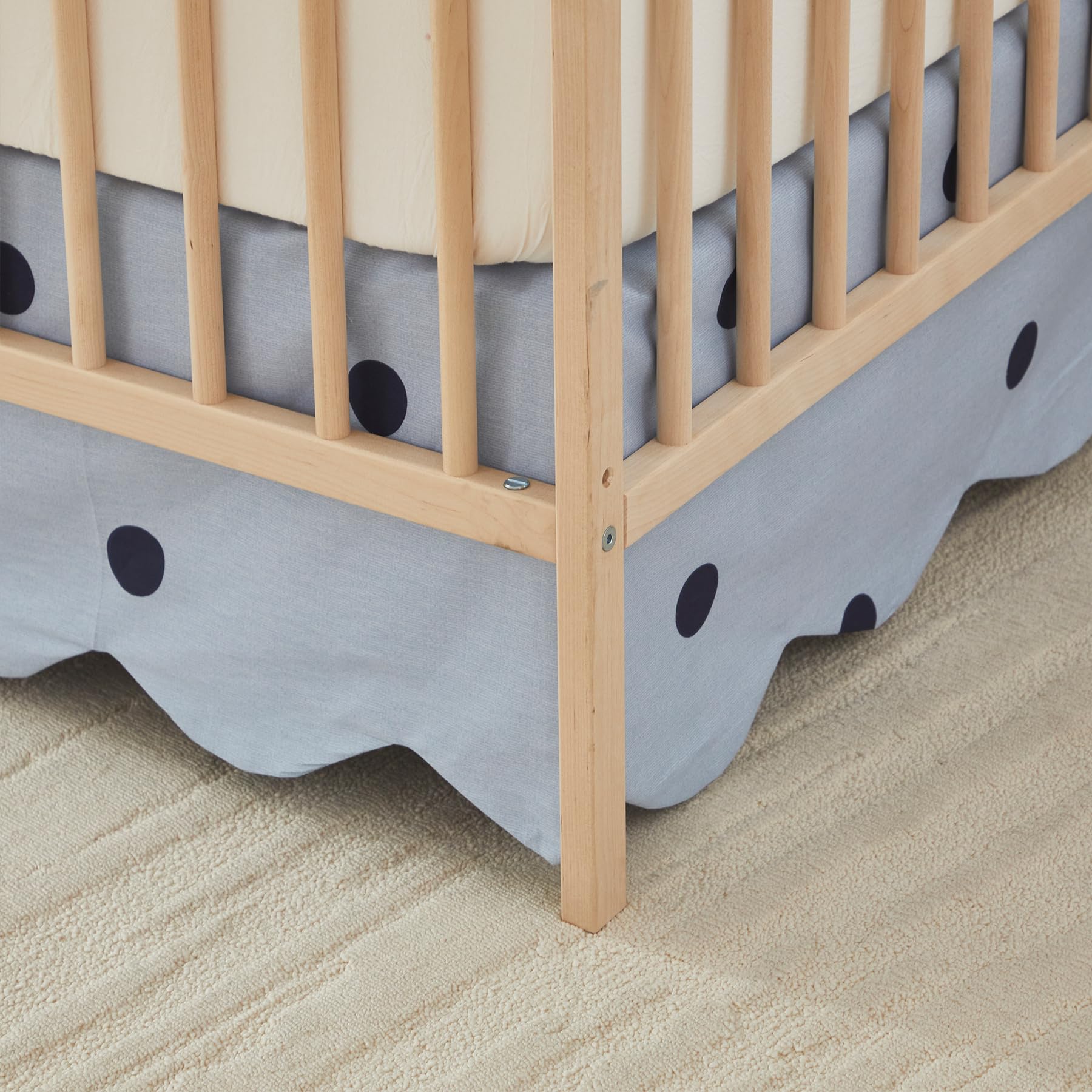 Brandream scallop edge crib skirt coordinates with gender-neutral nursery style.