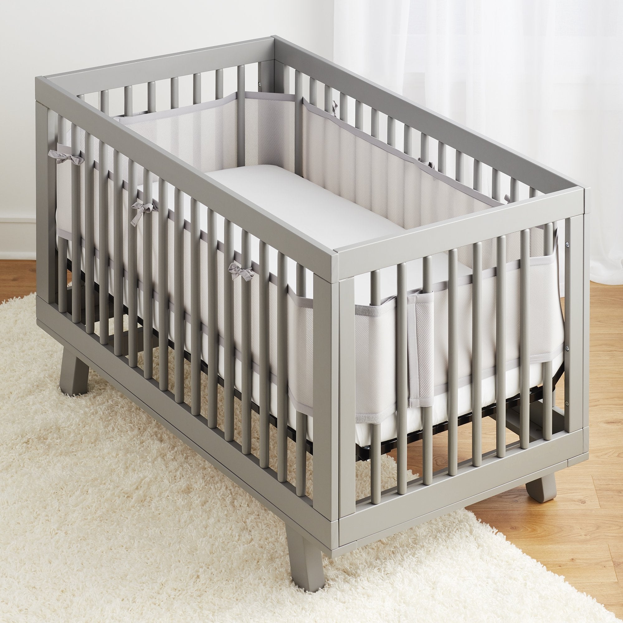 BreathableBaby crib liner long-panel installation showing 4-sides coverage and easy fit.