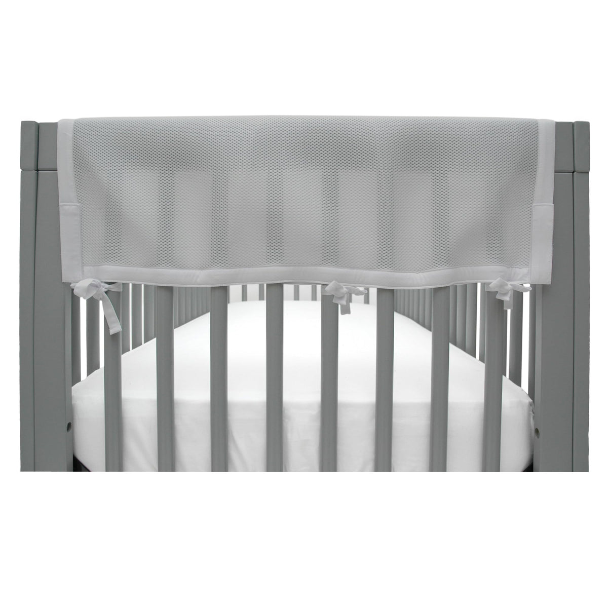 BreathableBaby RailGuard attached to crib rail in gray for teething protection