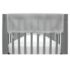 BreathableBaby RailGuard attached to crib rail in gray for teething protection